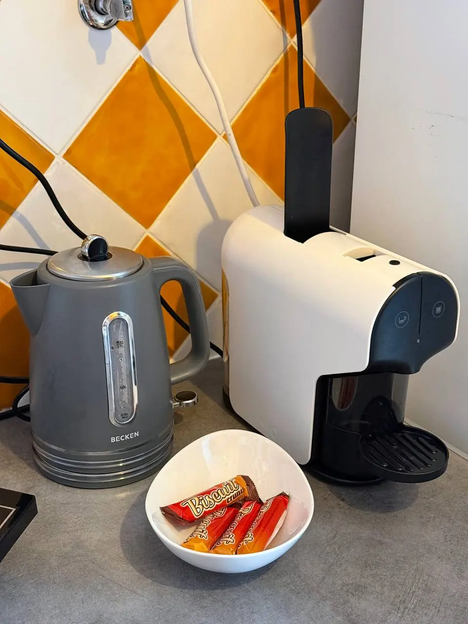 Coffee corner with electric kettle, capsule coffee machine, and welcome snacks